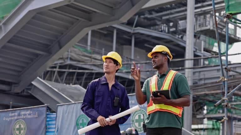 Engineer inspecting a bridge with a tablet